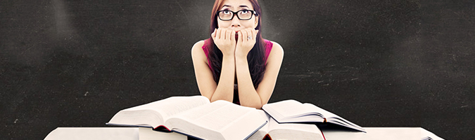 recuperacao escolar aluna preocupada com livros sobre a mesa